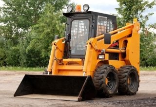 A Close-up of skid steer on construction site for providing skid steer training course to trainee who wants to obtain skid steer ticket in sydney.